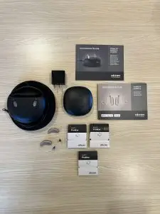 used oticon more 2 hearing aids product listing with standard charger, hard carrying case, original manuals, and wax guards
