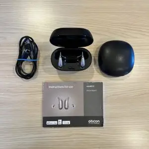 used oticon intent 1 hearing aids in premium charger with cable, hard case, and manual