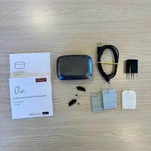 used resound nexia hearing aid product listing with manuals, charger, cord, wall plug, wax guards