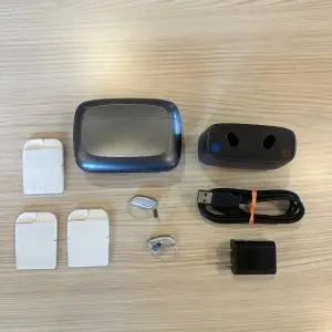 Used ReSound Vivia 9 hearing aid listing with desktop charger, premium charger, wax guards, cable, and wall plug